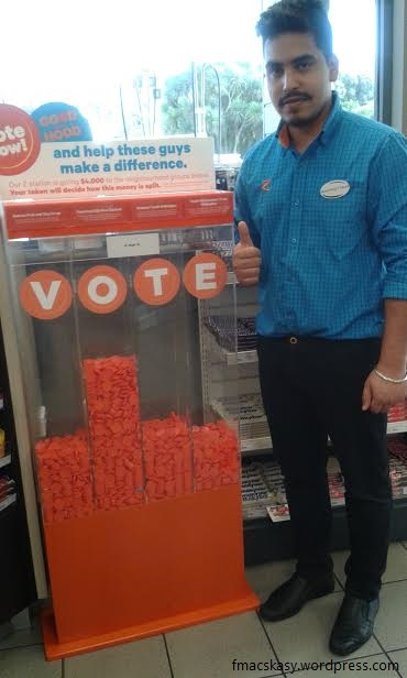 Manpreet, standinmg beside Coin-Vote Box, at Z Service Station in Hutt Valley